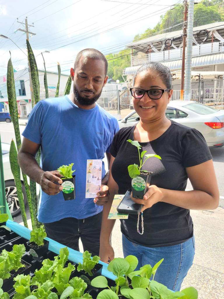 Couple with free seedlings distributed by Belgroves Funeral Home. 